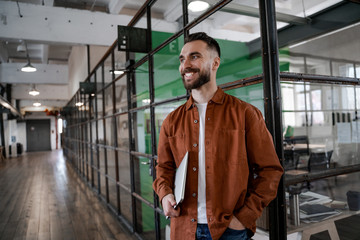 Bearded adult freelancer coworker in office space with laptop computer. Successful business strategy plan concept. Confident office worker indoor in coworking space. People lifestyle