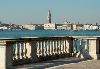 Balustrade in front of Campanile and Doge palace in Venice on a sunny day in winter