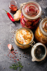 Fermented cabbage, fermented vegetables, kimchi, sauerkraut in glas jars, marinated canned food, natural probiotics, healthy eating, prebiotic rich food for digestion, immunity boost - 323498539