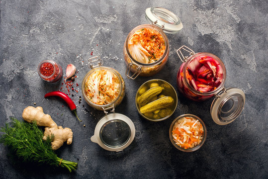 Different fermented vegetables, kimchi, sauerkraut in glas jars, marinated canned food, natural probiotics, healthy eating, prebiotic rich food for digestion, weight loss and immunity boost