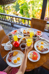 Young woman having breakfast in outdoors cafe