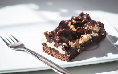 Portion of chocolate and almond cake with fork