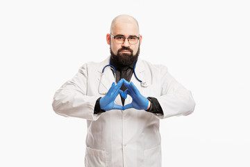 Male doctor in a white coat with a stethoscope and gloves. White background.