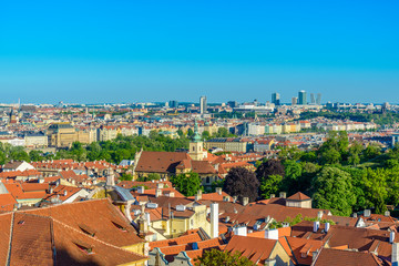 Fototapeta na wymiar Top view to red roofs and green trees skyline of Prague city Czech republic.