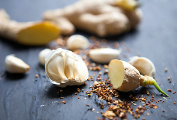 Garlic, species and ginger on a black background. Food ingredients. Cooking concept.Food photo. Fresh natural garlic on black table