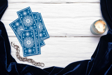 Fototapeta na wymiar Blue tarot cards on white table background with copy space.