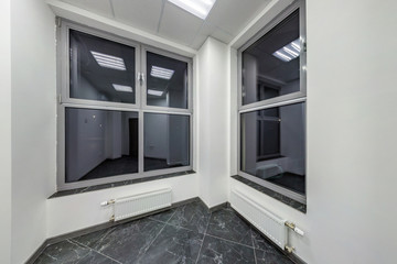 big windows in empty unfurnished room interior in white style color in modern apartments,  office or clinic