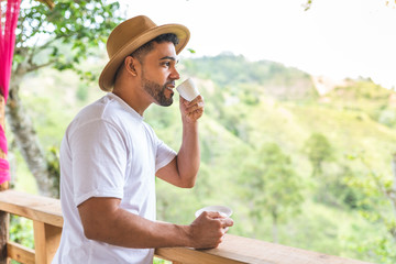 Latin American Man Drinking Coffee in the Mountain.