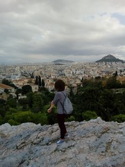 a girl enjoying the beautiful view over the city of Athens