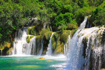 A picturesque waterfall among large stones in the Krka waterfalls, Lakes Landscape Park, Croatia in...