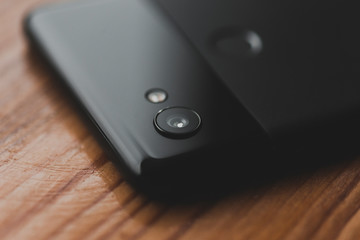 top view of google pixel smartphone lens on wooden background