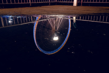 Long exposure reflection on a puddle of the Seattle Great Wheel