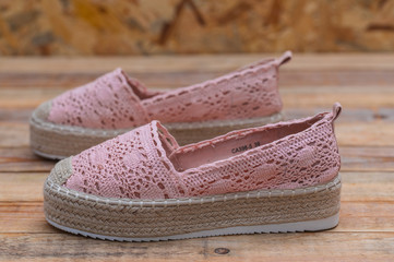 Espadrilles with rubber sole on wood background, close-up