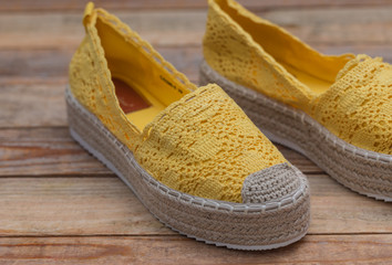 Espadrilles with rubber sole on wood background, close-up