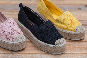 Espadrilles with rubber sole on wood background, close-up