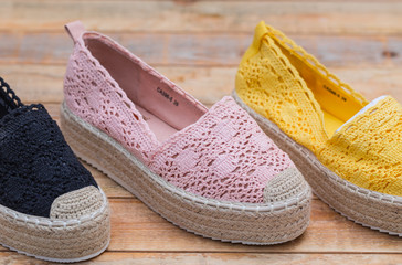 Espadrilles with rubber sole on wood background, close-up