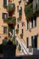 small square with well and a building with flowers 