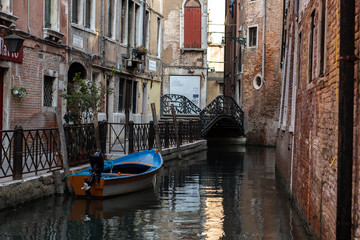 Boat moored in venetian canal
