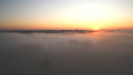 Fototapeta na wymiar Morning fog over the river in the city.