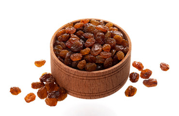 Raisins in wooden bowl isolated on white background
