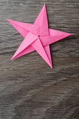 A pink origami paper star with copy space