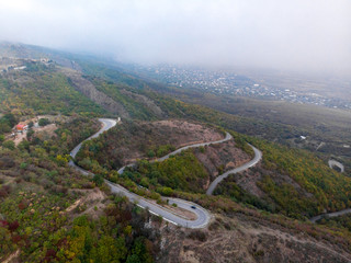 Fototapeta na wymiar Sighnaghi serpentine road. Foggy weather.