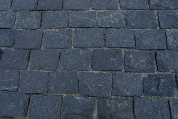 Dark grey stone road texture.