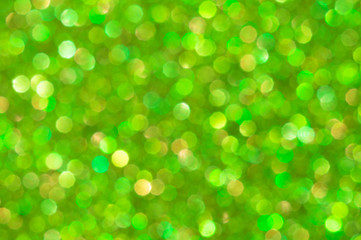 Fototapeta na wymiar Bright green blurred background with no focus. Original bokeh. Universal copy space.