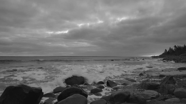 Beautiful morning at the rocky beach with gorgeous clouds and a glow in the sky