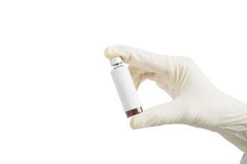 Human hand in glove holding a vaccine bottle