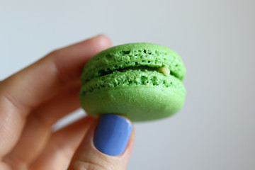 hand holding green macaron