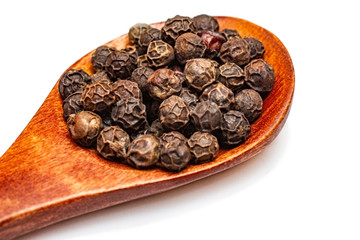 Black pepper peas in a wooden spoon.
