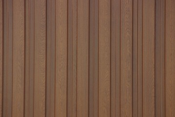 brown texture of striped boards in the wall of a fence in the street