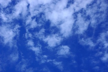 many white clouds on a bright blue sky on a sunny day