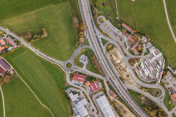 Top down aerial view of freeway interstate road with moving traffic cars in rural area.