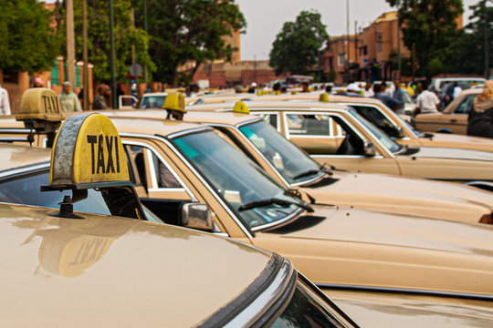 row of old taxis in morocco