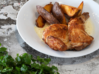 Grilled half chicken with baked potatoes