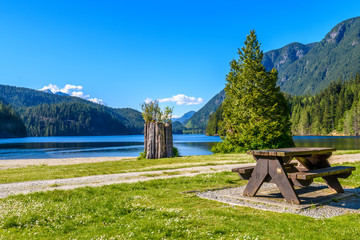 A picnic table with gorgeous view at Bantzen Lake, Vancouver, British Columbia, Canada.