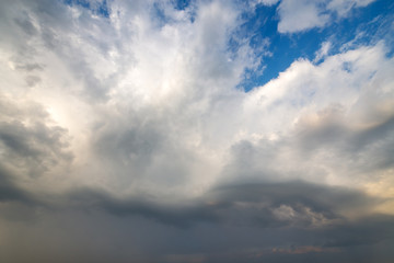 Blue sky covered with white puffy clouds.