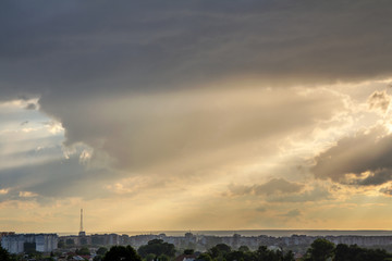 Sunset sky covered with dramatic storm puffy clouds before rain.