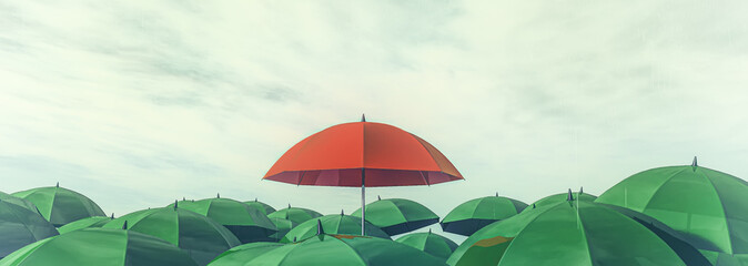 red umbrella standing out among other greens