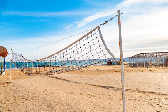 Beach volleyball net on sandy beach in tourist resort camp