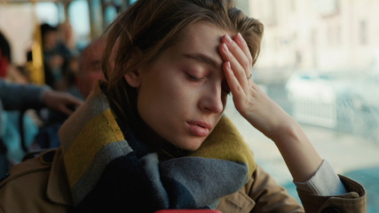 Portrait young attractive woman look on window on the tram on a cold autumn day at the start of the...