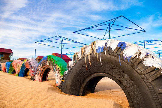 Playground made from used tires on sandy beach at the tourist resort