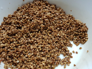 Wet buckwheat porridge close up in white pan