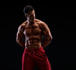 Fototapeta na wymiar Handsome Muscular Men, Bodybuilder posing and Flexing Muscles. Copy Space