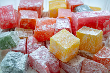 Heap of colorful Turkish delight isolated on white background