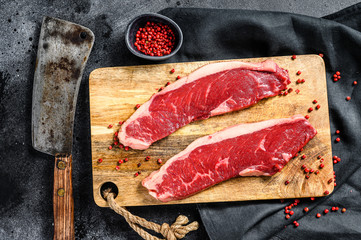 Fototapeta na wymiar Strip loin steak on a cutting Board. Organic beef meat. Black background. Top view