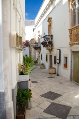 Fototapeta na wymiar Narrow white streets of Locorotondo in Puglia (Apulia) region, southern Italy
