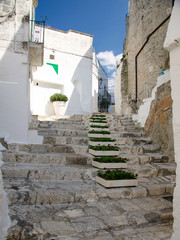 Narrow streets of the town of Ostuni with white buildings in Puglia Apulia region, Southern Italy